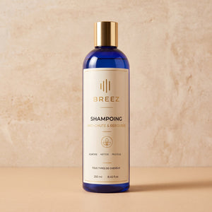 Flacon du Shampoing anti-chute BREEZ posé sur du travertin